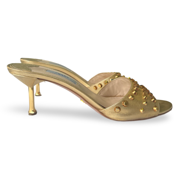 Gold high heel slide sandals featuring a studded design and a slim heel.
